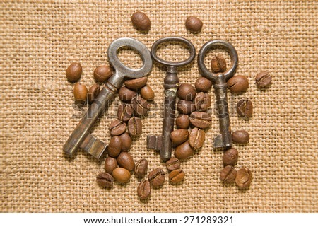 Vintage keys and coffee beans on old cloth