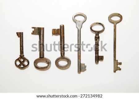 Six vintage keys to the safe on a white background
