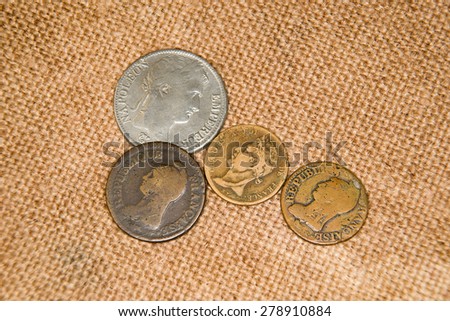 A lot of old  coins with portraits on the old cloth