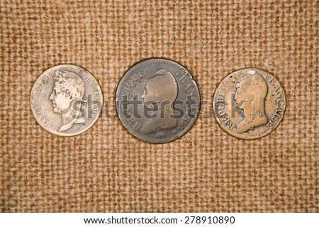 A lot of old  coins with portraits on the old cloth