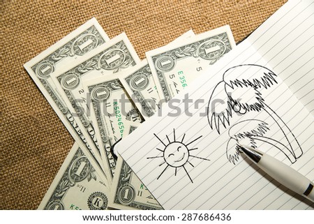 Opened notebook with a blank sheet, pen and money on the old tissue
