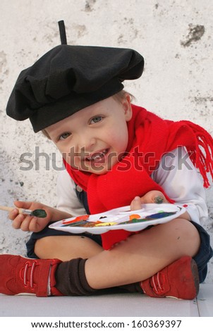 Portrait of a little boy enjoying his painting. Education. Isolated over white background.