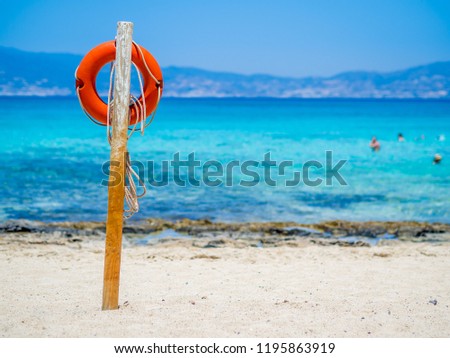 Chrissi Island, Crete, Greece. A lifebuoy on the Golden Beach, symbol of assistance, security, rescue, SOS. Golden Beach in Chrysi island, one of the wildness and gorgeus beach in the world
