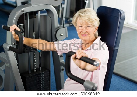 Senior lady working out at the gym