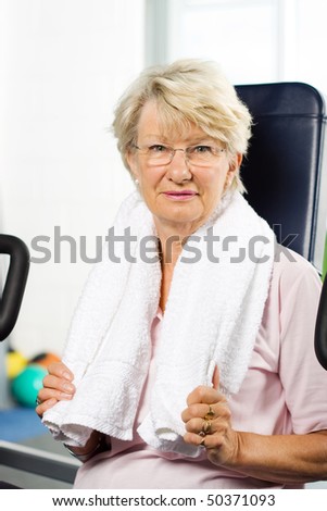 Senior lady working out at the gym
