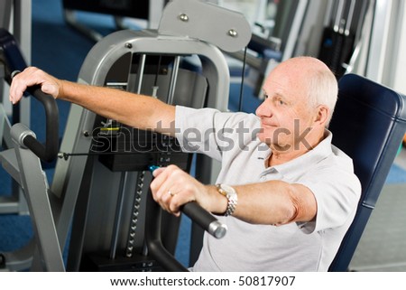 Mature older man working out in the gym