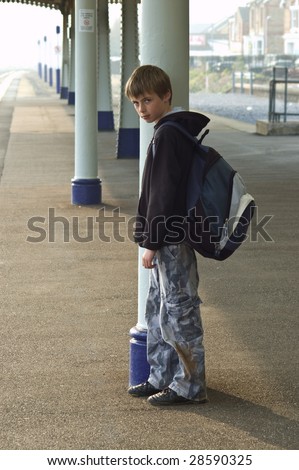 A Young Lonely Boy Waiting At A Train Station. Stock Photo 28590325 ...