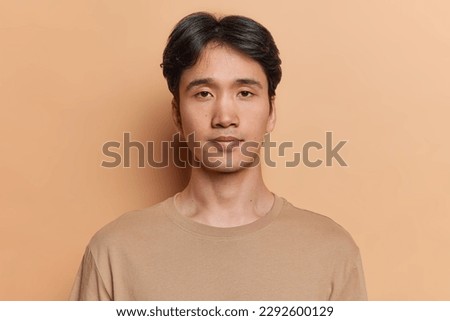 Similar – Image, Stock Photo Serious Asian man in face mask standing in gray corridor