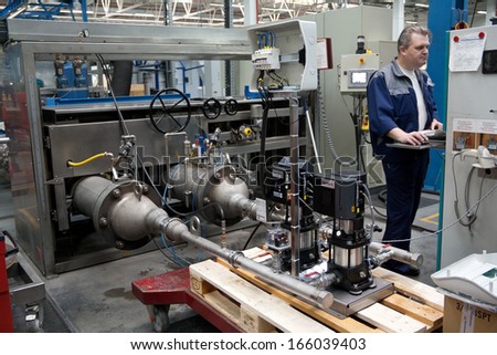ISTRA, RUSSIA 2012 APRIL 10: GRUNDFOS factory. Personnel testing a water pump under high pressure