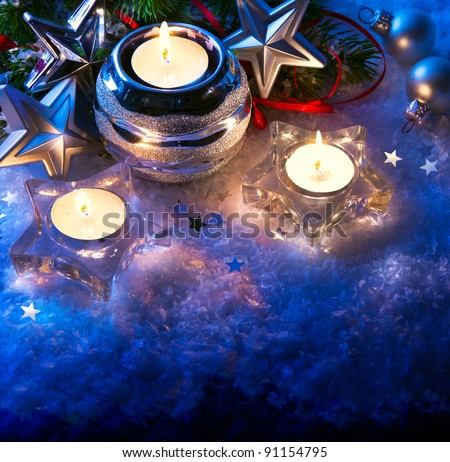 christmas greeting card with christmas candle decoration and christmas decoration on blue background