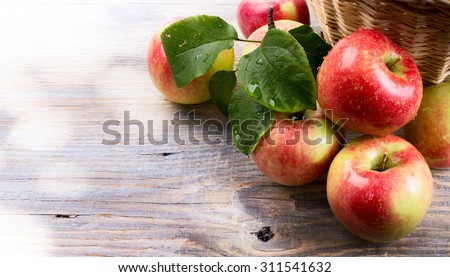 art Ripe red apples on wooden background