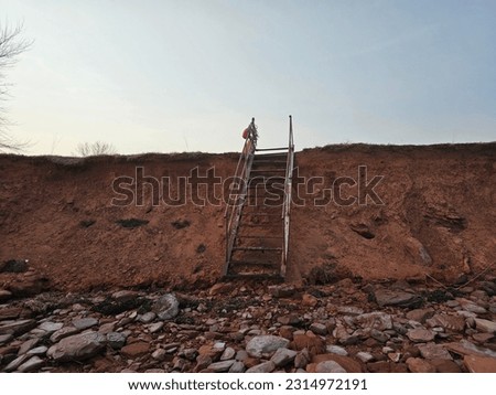 Similar – Foto Bild alte rostige Treppe mit Schäden gegen den blauen Himmel und die Wolken