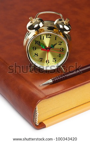 golden alarm clock on the book  isolated on a white background