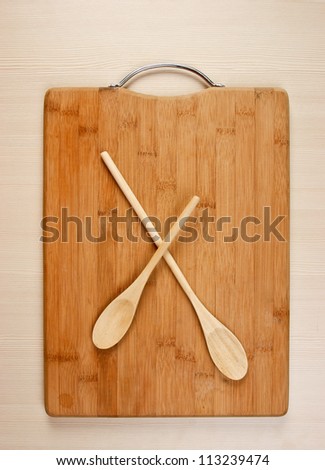 wooden spoon on the kitchen bamboo cutting board