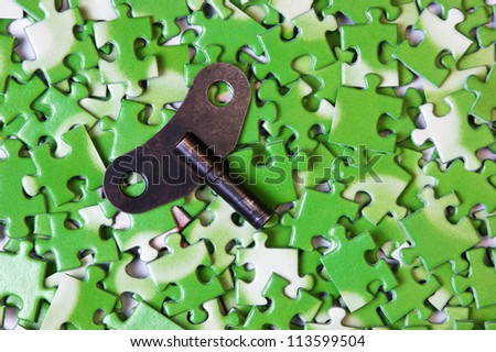 key on pile of green puzzle