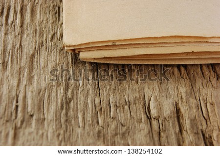 edge of the old newspaper on a wooden background