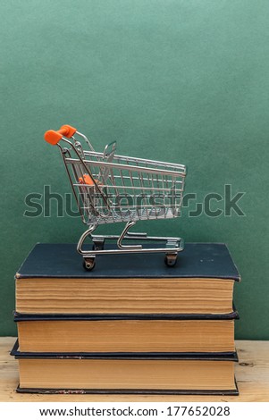 stack of old books on a wooden shelf and shopping carts