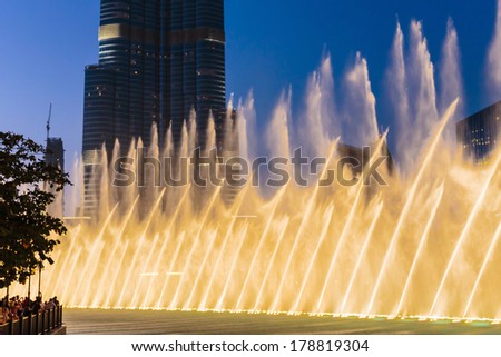 DUBAI, UAE - OCTOBER 31, 2013: Night view Dancing fountains downtown and in a man-made lake in Dubai, UAE. The Dubai Dancing fountains are world\'s largest fountains with height 150 m.