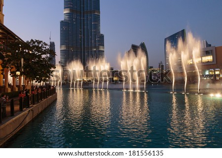 DUBAI, UAE - OCTOBER 31, 2013: Fountain in the lake near Dubai Mall. Lake - 6600 lights and 25 projectors, it shoots water 150 m into the air. United Arab Emirate