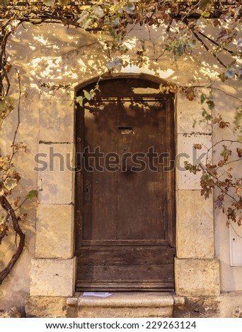 Old wooden door in the entrance stone French house