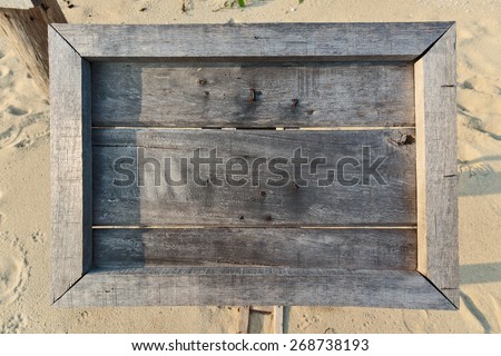 Empty old wooden menu board on a tropical beach