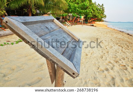 Empty old wooden Whiteboard (menu board) on a tropical beach