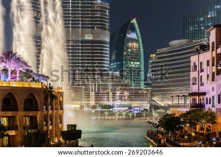 DUBAI, UAE - NOVEMBER 13: Night view Dancing fountains downtown and in a man-made lake in Dubai, UAE on November 13, 2013. The Dubai Dancing fountains are world\'s largest fountains with height 150 m.