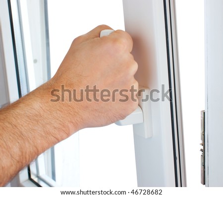 hand opens a window isolated on white