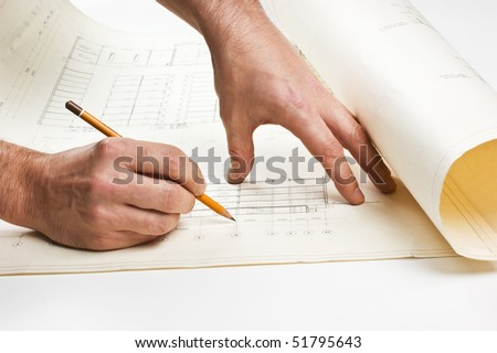 hand draws a pencil on the drawing