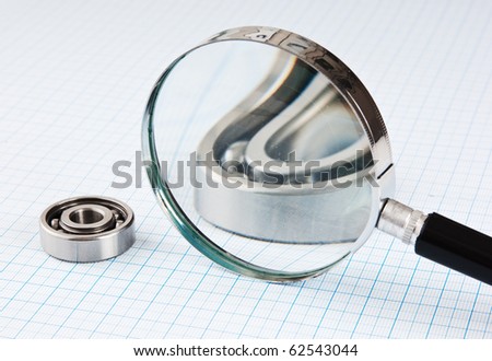 magnifying glass and  bearing on graph paper