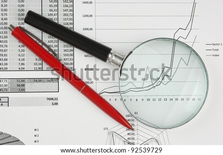 magnifying glass and working paper with  diagram