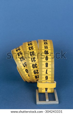 Yellow meter belt slimming on a blue background
