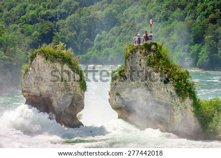 Rheinfall - biggest waterfall in Europe, located in Schaffhausen, Switzerland. Two massive rock in the middle of the river offering spectacular view to the tourists on top of them.