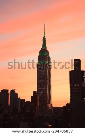 Empire state building at sunset. Orange, pink and purple hues of the sky in the background - May 28, 2015, Manhattan, New York City, NY, USA
