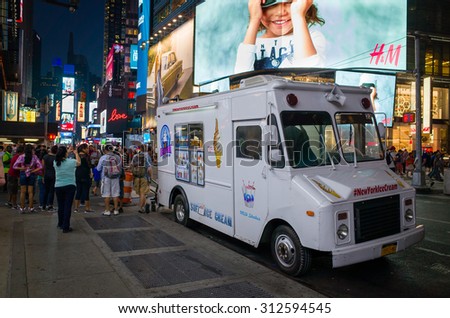 White ice cream truck on a crowded street in Times Square at night - September 1, 2015, Times Square, New York City, NY, USA