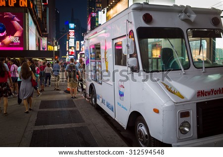 White ice cream truck on a crowded street in Times Square at night - September 1, 2015, Times Square, New York City, NY, USA