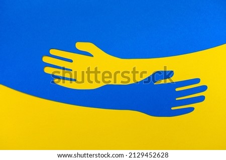 Support for Ukraine. Embrace icon, arms hugging in colors of Ukraine , War in Ukraine, attack from Russia. Papercut, hands hug linear vector logo template. Care, love and charity symbol, hand papercut Foto d'archivio © 