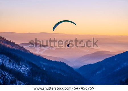Similar – Image, Stock Photo paragliding man with orange paraglider against the sun