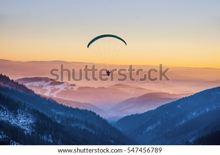 Similar – Image, Stock Photo paragliding man with orange paraglider against the sun