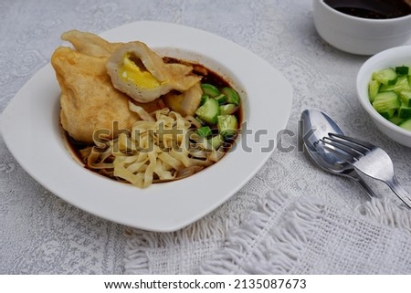 Pempek kapal selam: (Indonesian: submarine pempek), which is made from a chicken egg wrapped within the pempek dough and then deep-fried. The shape is similar to Chinese dumplings but larger in size. Stok fotoğraf © 
