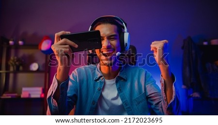 Image, Stock Photo Young man with mobile phone in the autumn park