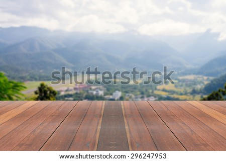 Vintage wooden board table in front of summer landscape. Perspective wood floor over blur city with bokeh background - can be used for display or montage your products. Blurred background.