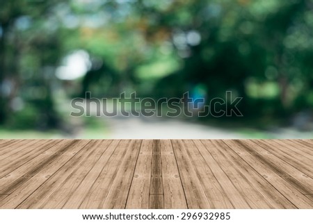 Wooden board empty table in front of blurred background. Perspective grey wood over blur trees in forest - can be used for display or montage your products. spring season. vintage filtered image.