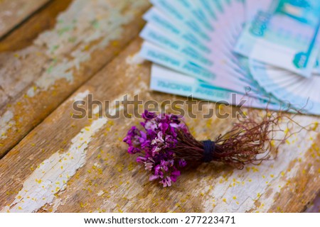 bouquet of flowers wrapped in a dollar bill