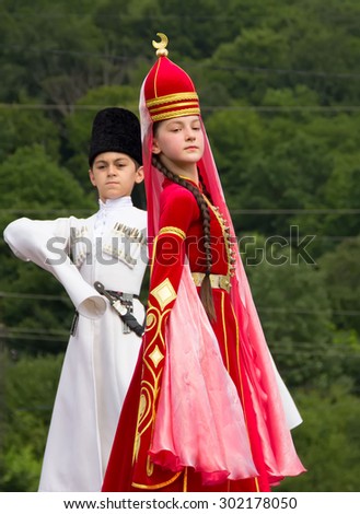DAKHOVSKY, RUSSIA - JULY 25 2015: The boy and the girl in beautiful national suits dance traditional Adyghe dance. The Festival \