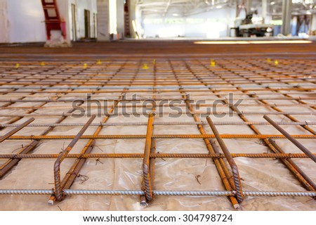 the reinforcing grid fastened with a wire from a channeled steel rod under filling of concrete floors