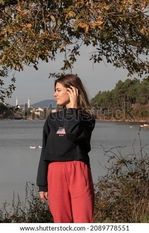 Similar – Image, Stock Photo Lonely woman admiring autumn landscape of lake and mountains