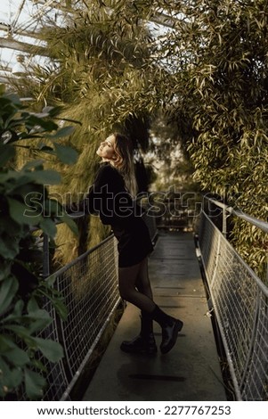 Young, beautiful woman communes with the nature. Full of green plants. Foto d'archivio © 