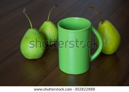 Green cup and three pears. Still Life. Natural light.