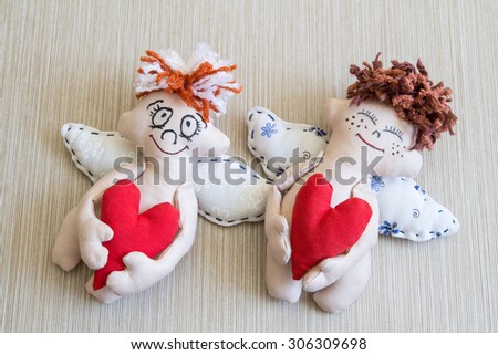 Happy Angel hugging red heart. Pair. Soft toys.